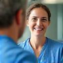 Friendly clinic team member providing post-treatment support
